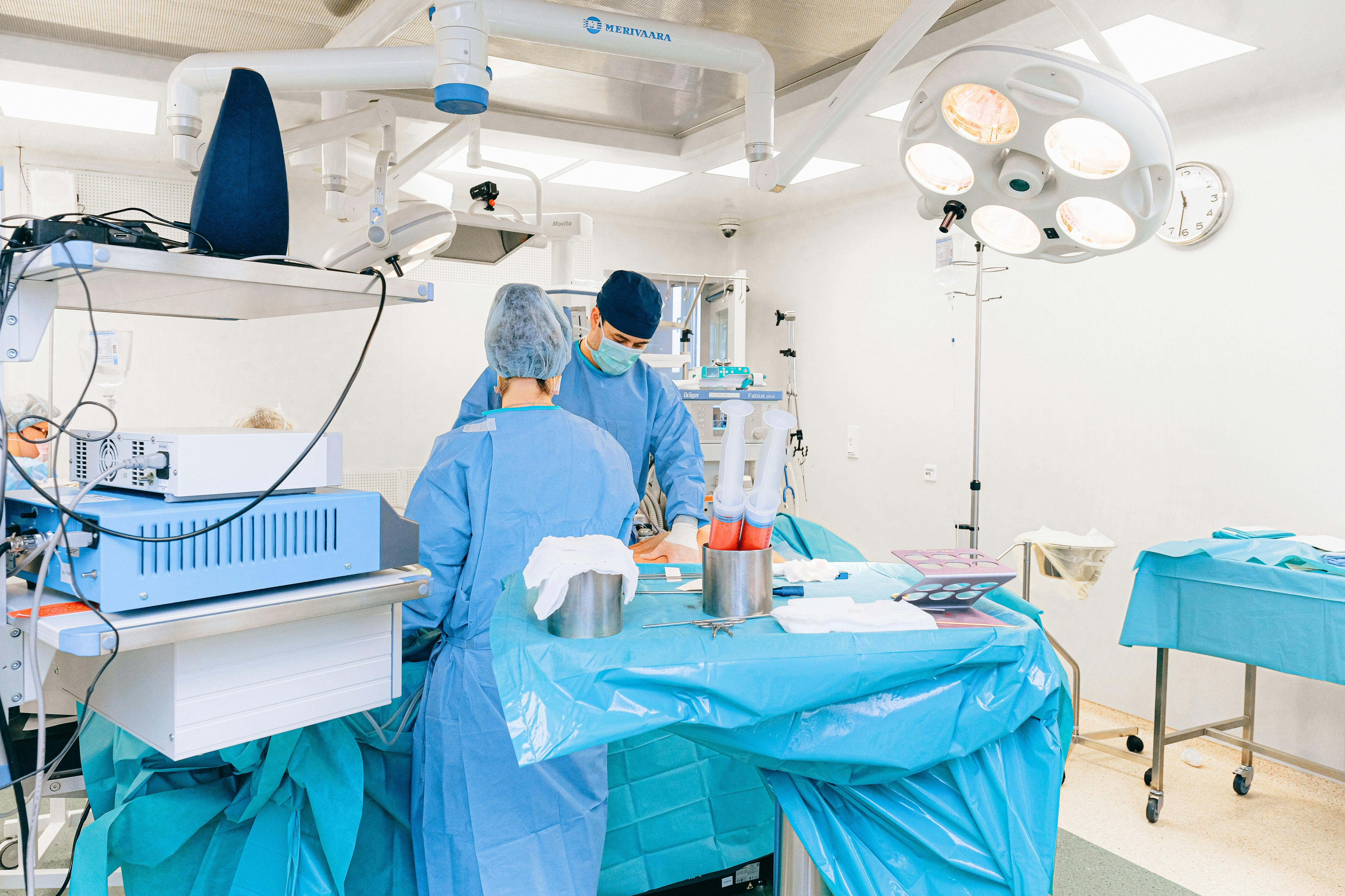 Surgeons in an operating room performing medical procedures with precision and care.